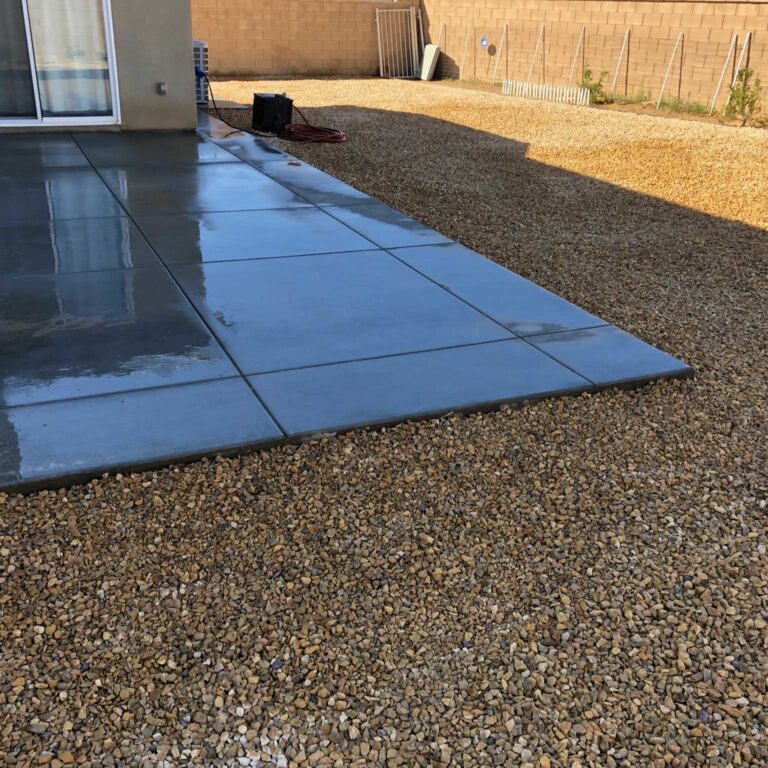 A patio with a tile floor and a black tarp.