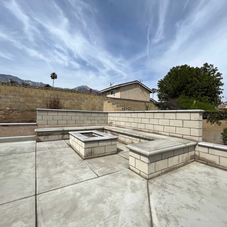 A large patio with fire pits and benches.