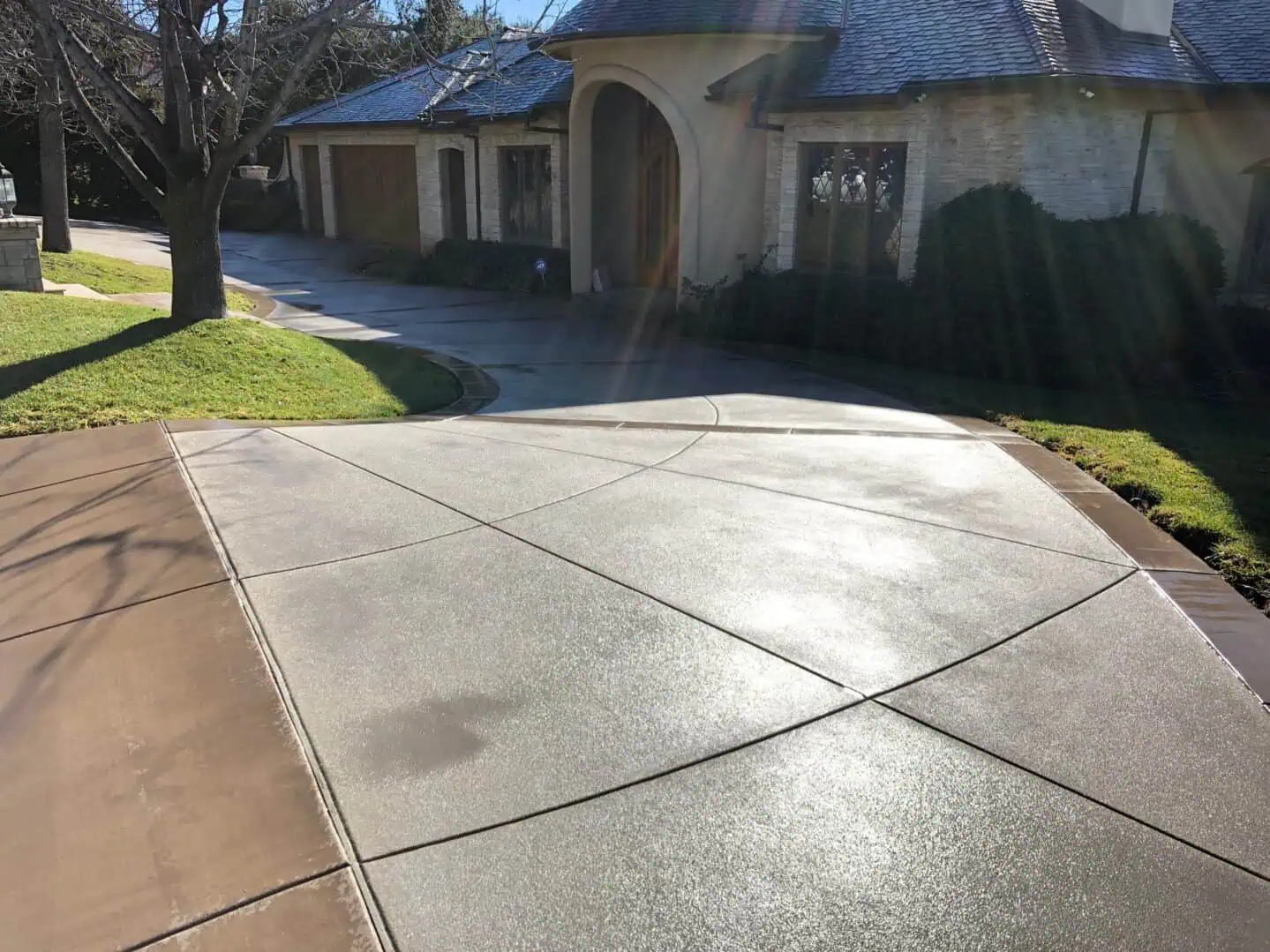 A driveway with concrete on the side of it