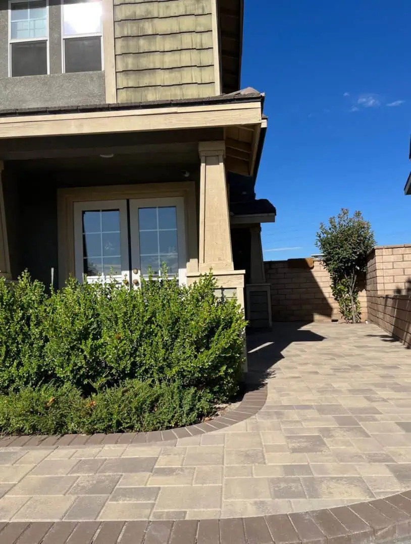 A house with a garden and bushes in the yard