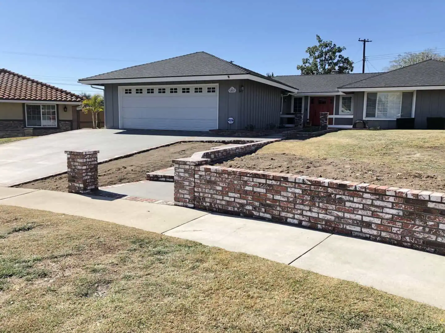 A brick wall in front of a house