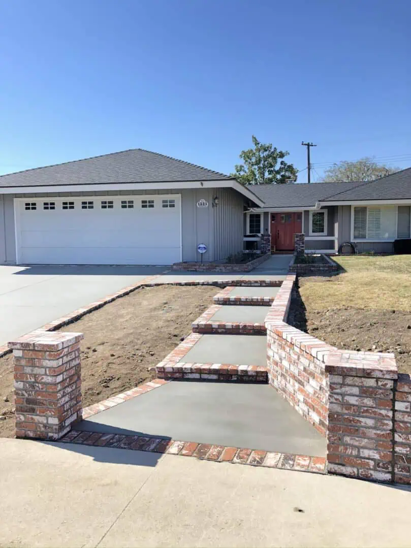 A house with brick steps leading to the driveway.