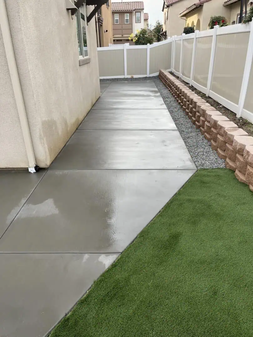 A walkway with grass and concrete in the middle of it.