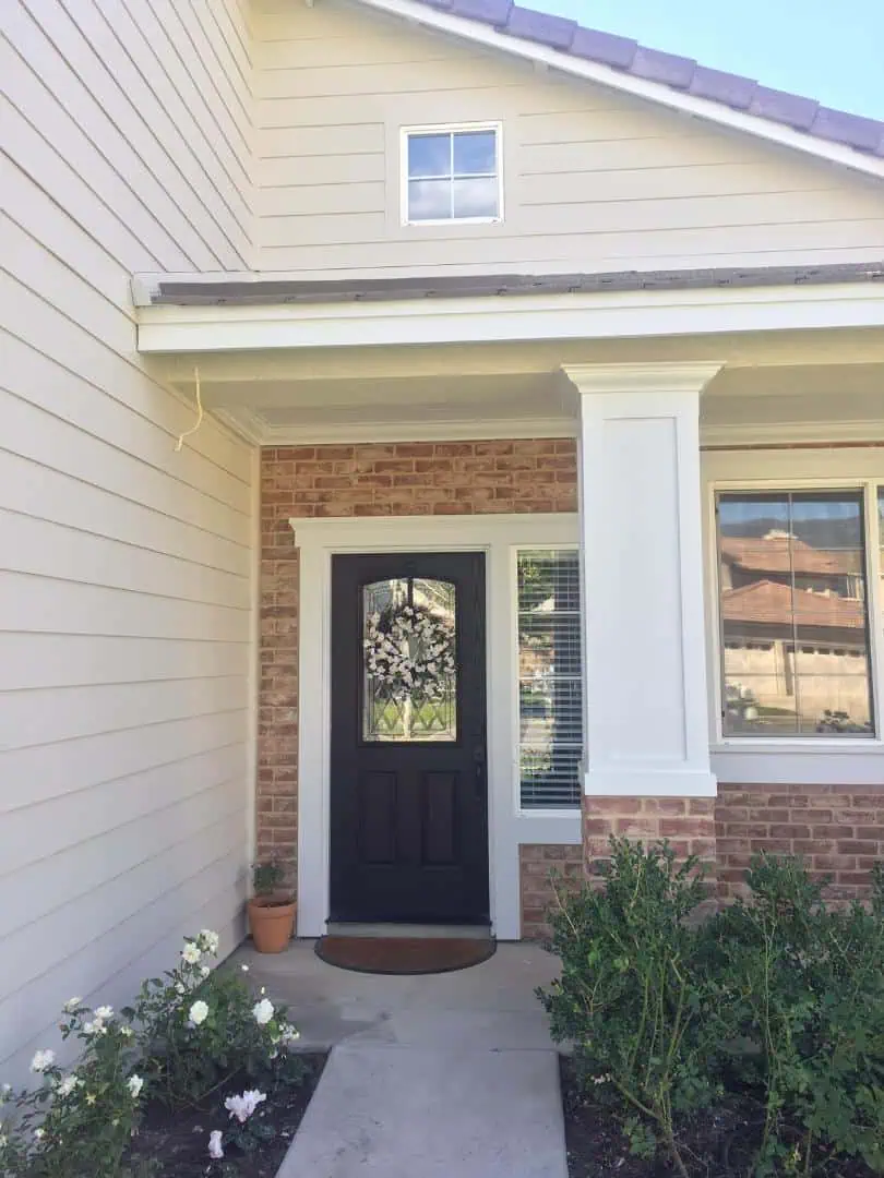 A black door and white trim on the front of a house.