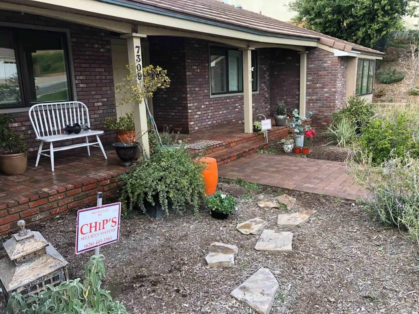 A house with a lot of plants in the yard