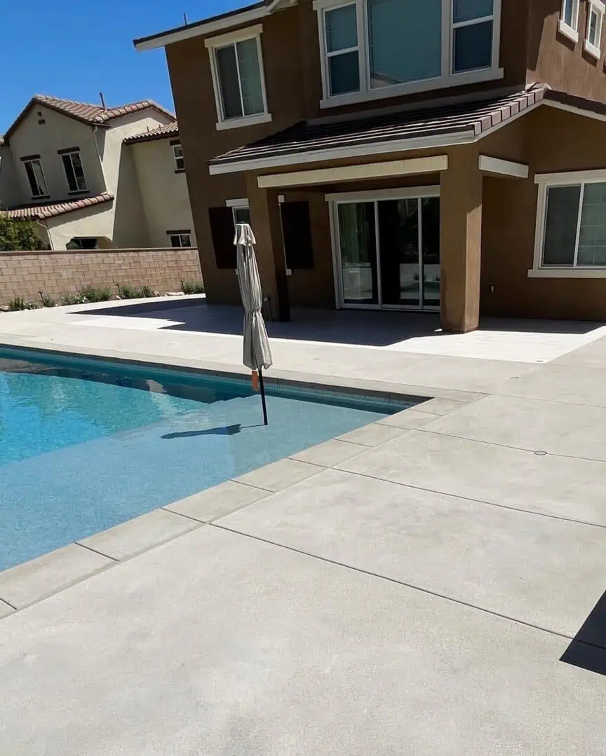 A pool with a house in the background