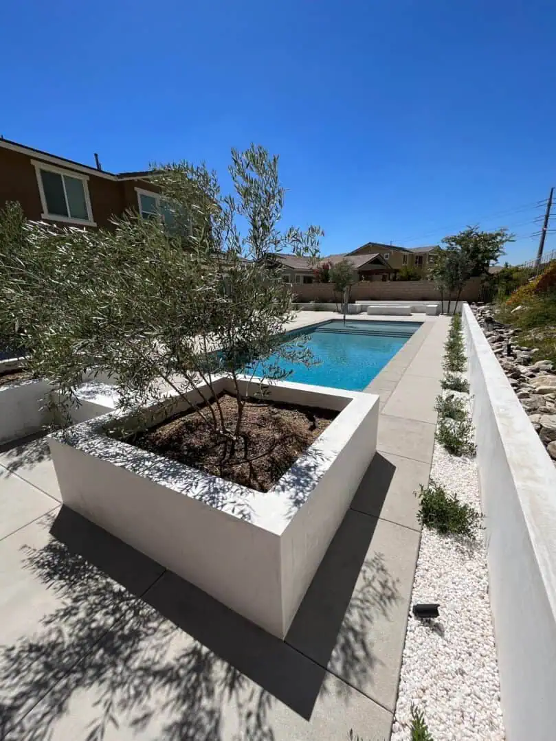 A pool with a planter in the middle of it
