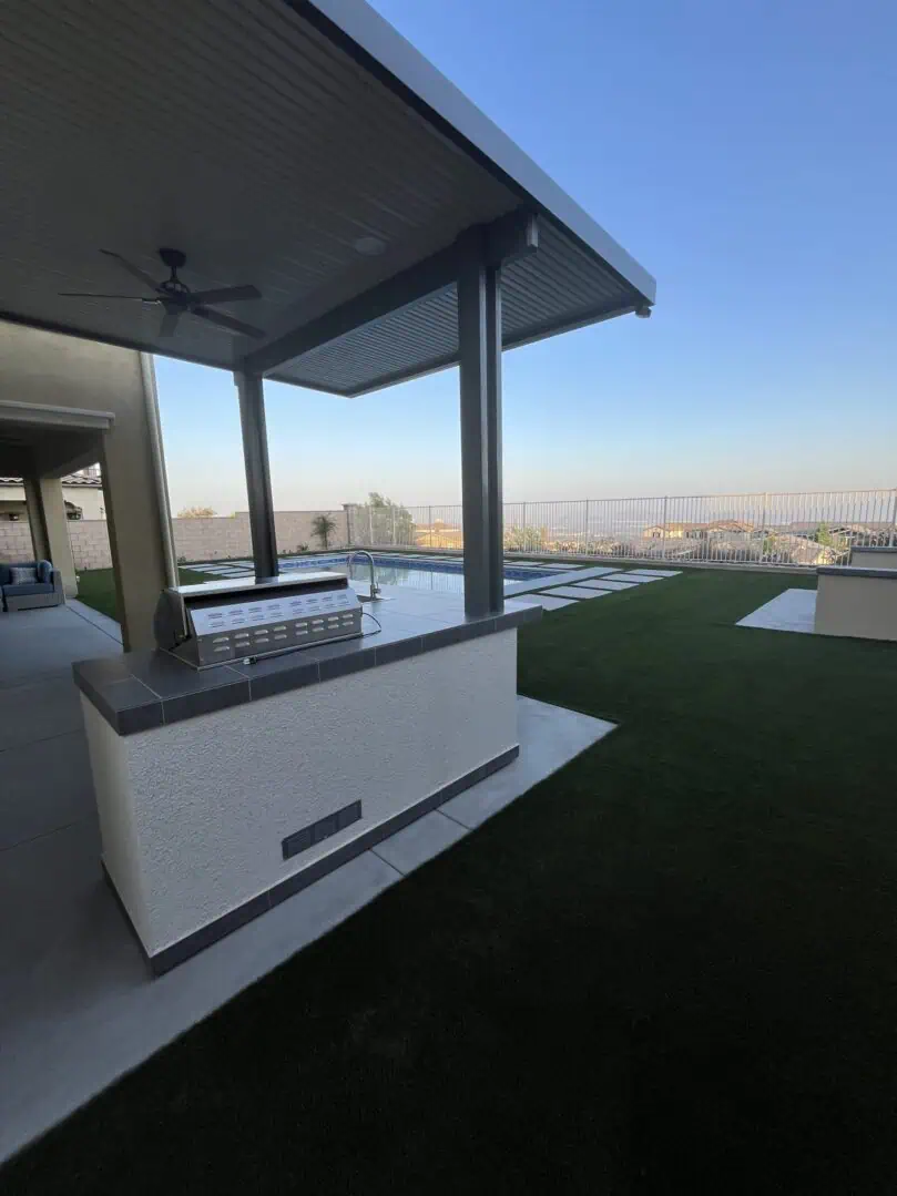 A view of an outdoor area with a pool and a city skyline.