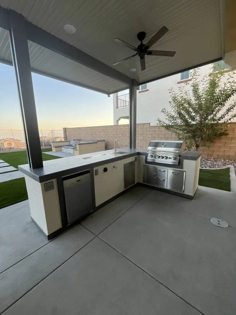 A large outdoor kitchen with an oven and grill.