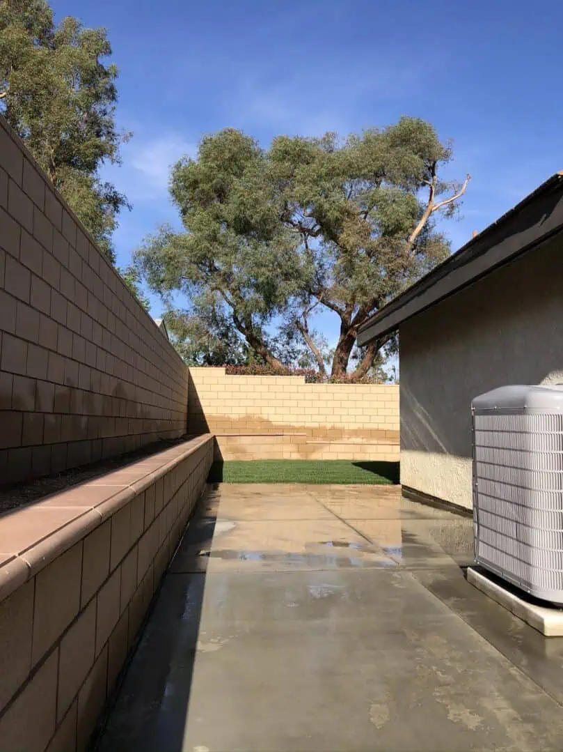 A large air conditioner sitting outside of a house.