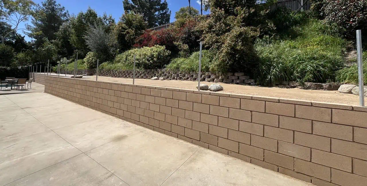 A concrete wall with trees in the background
