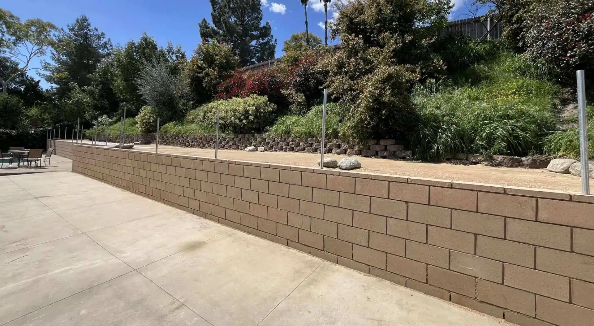 A brick wall with trees in the background