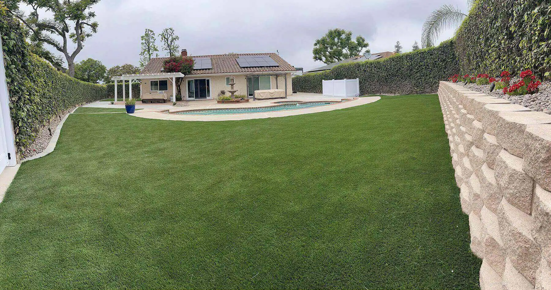 A large yard with a pool and a house