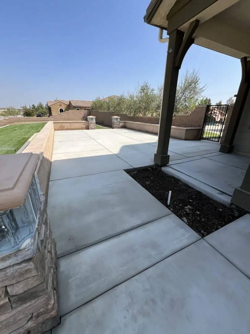 A patio with a fire pit and a large planter.