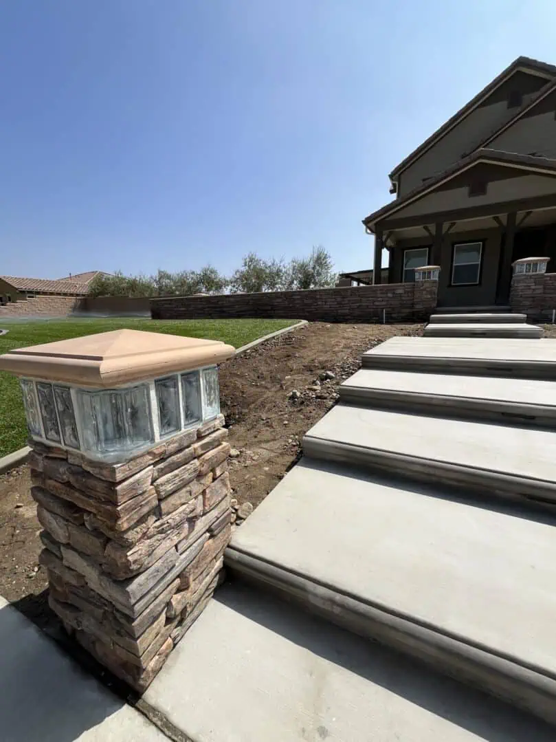 A brick pillar with a light on top of it.