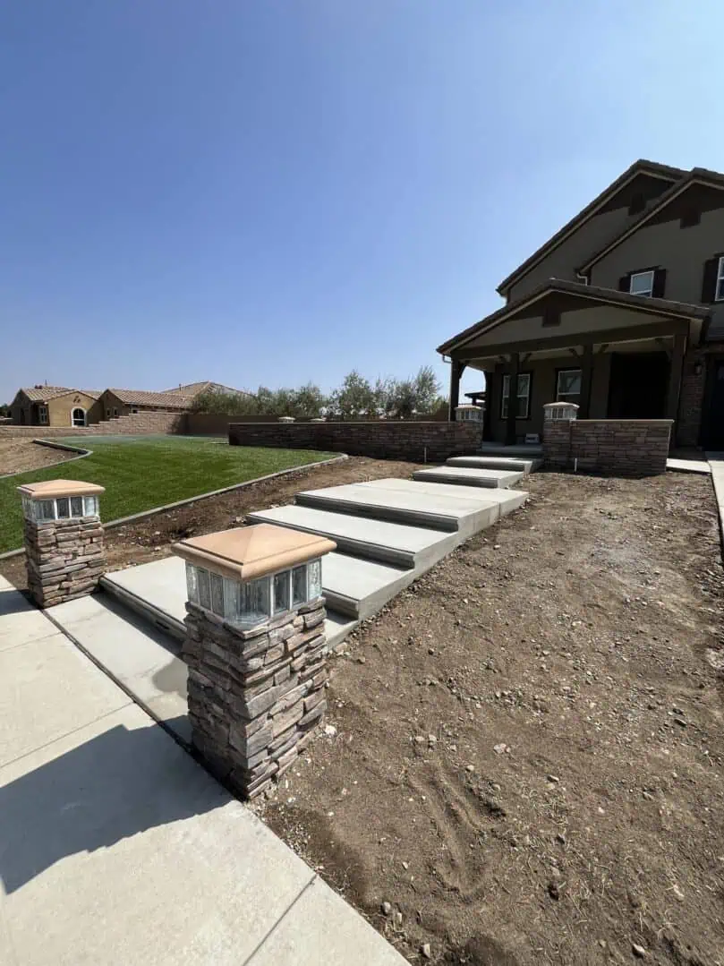 A house with steps leading to the front yard.