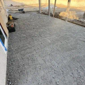 Under-construction patio area with gravel surface.
