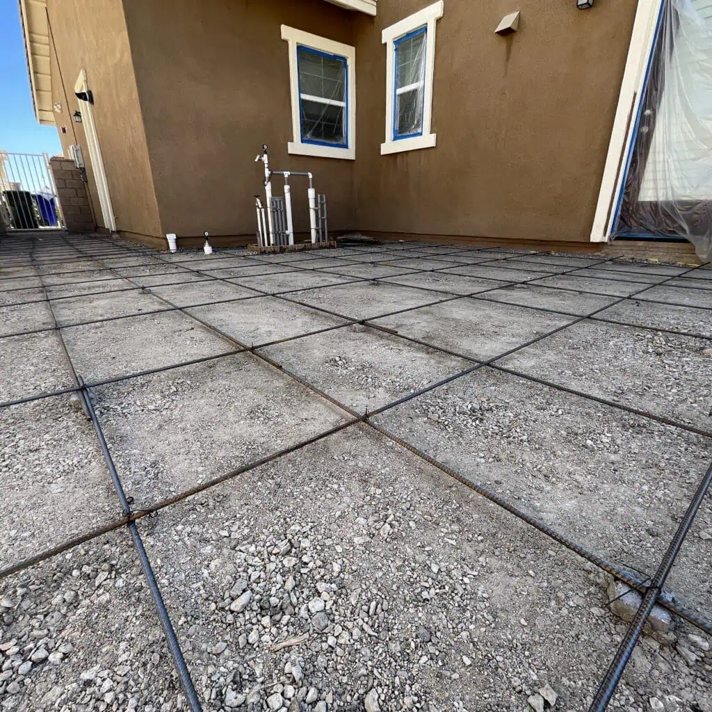 Concrete foundation preparation with rebar grid.