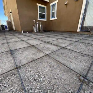 Concrete foundation preparation with rebar grid.