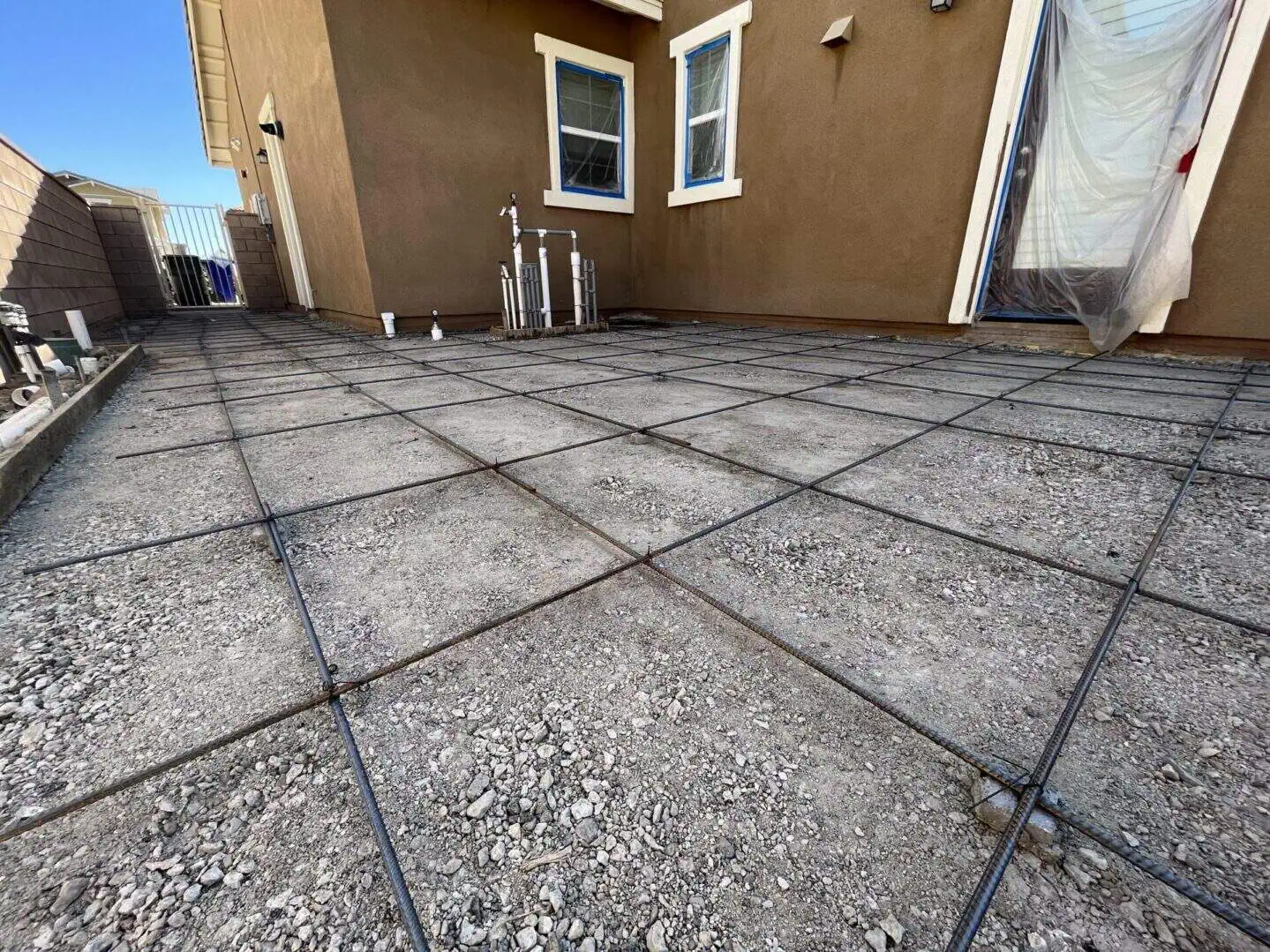 Concrete foundation preparation with rebar grid.