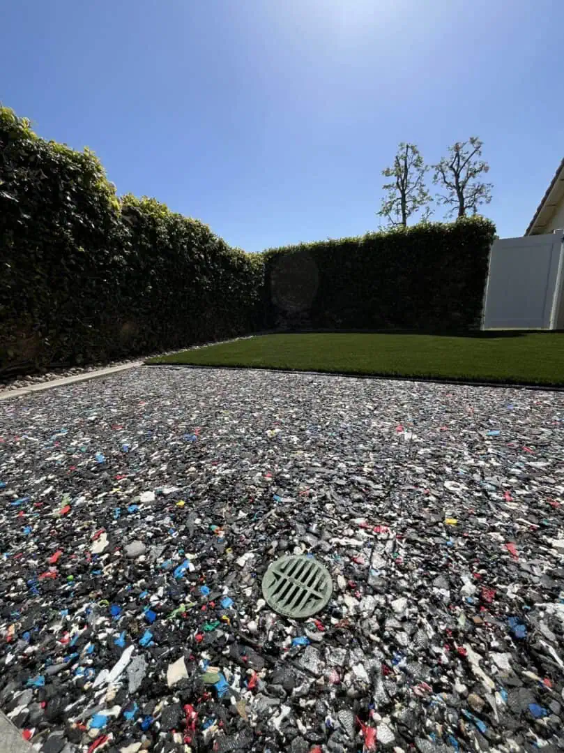 Recycled material surface in sunny backyard.